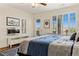 Bright bedroom with plantation shutters, a ceiling fan, and a view of the surrounding landscape at 1309 Vista Del Monte Dr, Mesquite, NV 89027