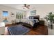 Bright bedroom featuring hardwood floors, a stylish ceiling fan, and a comfortably furnished bed at 1309 Vista Del Monte Dr, Mesquite, NV 89027