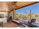 Covered patio with outdoor seating, ceiling fans, and a view of the landscaped backyard at 1309 Vista Del Monte Dr, Mesquite, NV 89027
