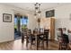Elegant dining area with patio access, stylish lighting, and wood floors at 1309 Vista Del Monte Dr, Mesquite, NV 89027