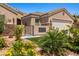 Home entrance featuring desert landscaping, a secure gate, and a decorative wall art piece at 1309 Vista Del Monte Dr, Mesquite, NV 89027