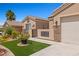 Close up of the home's entrance with desert landscaping, decorative stone accents, and an address plaque at 1309 Vista Del Monte Dr, Mesquite, NV 89027