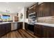 Well-equipped kitchen with dark wood cabinets and stainless steel appliances at 1309 Vista Del Monte Dr, Mesquite, NV 89027