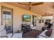 Outdoor covered patio with ceiling fans, TV, and comfortable seating area at 1309 Vista Del Monte Dr, Mesquite, NV 89027