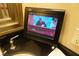 Bathroom vanity with television next to sink and classic faucet at 145 E Harmon Ave # 27619, Las Vegas, NV 89109