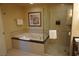 Features a tub with a glass door shower in bathroom at 145 E Harmon Ave # 27619, Las Vegas, NV 89109