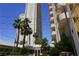 Exterior shot of modern high-rise buildings surrounded by tropical palm trees at 145 E Harmon Ave # 27619, Las Vegas, NV 89109