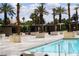 Resort-style pool with palm trees, cabanas, lounge chairs, and tiled deck, offering a relaxing outdoor experience at 145 E Harmon Ave # 27619, Las Vegas, NV 89109