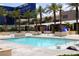 Bright and clear pool view with palm trees, cabanas, lounge seating, and the MGM Grand in the background at 145 E Harmon Ave # 27619, Las Vegas, NV 89109