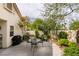 Well-maintained backyard featuring a patio with outdoor furniture, a grill, and a garden with various desert plants at 1632 Royal Canyon Dr, Las Vegas, NV 89128