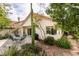 Spacious backyard with a patio area, outdoor seating, desert plants, and views of the home's exterior at 1632 Royal Canyon Dr, Las Vegas, NV 89128