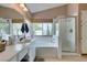 Bathroom with a double vanity, soaking tub, a walk-in shower, and a large window at 1632 Royal Canyon Dr, Las Vegas, NV 89128
