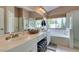 Bathroom featuring a double vanity, soaking tub, shower, and natural light at 1632 Royal Canyon Dr, Las Vegas, NV 89128