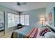 Bedroom featuring a large window, stylish bedding, and neutral color scheme at 1632 Royal Canyon Dr, Las Vegas, NV 89128