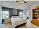 Bedroom featuring a blue accent wall, vaulted ceiling, and views to the bathroom at 1632 Royal Canyon Dr, Las Vegas, NV 89128