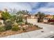 Charming single-story home with a well-manicured desert landscape and a two-car garage at 1632 Royal Canyon Dr, Las Vegas, NV 89128