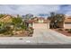 Inviting one-story home featuring drought-tolerant landscaping, a tile roof, and a spacious two-car garage at 1632 Royal Canyon Dr, Las Vegas, NV 89128