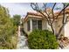 Charming front exterior featuring desert landscaping, privacy bush, and a tile roof at 1632 Royal Canyon Dr, Las Vegas, NV 89128
