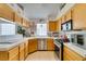 Compact kitchen featuring stainless steel appliances and tile floors at 1632 Royal Canyon Dr, Las Vegas, NV 89128
