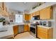 Bright kitchen area featuring stainless appliances and tile countertops at 1632 Royal Canyon Dr, Las Vegas, NV 89128
