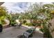 Inviting outdoor patio featuring a seating area, lounge chairs, and lush greenery, perfect for relaxation at 1632 Royal Canyon Dr, Las Vegas, NV 89128