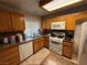 Traditional kitchen with tile backsplash, granite countertops, and white appliances at 1749 Green Apple Way, Las Vegas, NV 89142