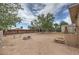 Spacious backyard with a fire pit area, mature trees, and partial fencing at 240 N 19Th St, Las Vegas, NV 89101