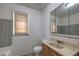 A modest bathroom is equipped with a vanity, mirror, toilet, and tiled shower at 240 N 19Th St, Las Vegas, NV 89101
