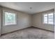 A well-lit bedroom features neutral walls, carpet flooring, and two windows for natural light at 240 N 19Th St, Las Vegas, NV 89101