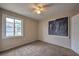 A sunlit bedroom with plush carpet and a ceiling fan for comfort at 240 N 19Th St, Las Vegas, NV 89101