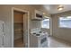 A clean kitchen features white appliances, tile floors, and a view of an adjacent pantry at 240 N 19Th St, Las Vegas, NV 89101