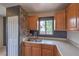 An updated kitchen is furnished with wooden cabinets, a dual-basin sink, and a view of the yard at 240 N 19Th St, Las Vegas, NV 89101