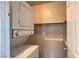 A simple laundry area contains a stacked washer and dryer with built-in shelving at 240 N 19Th St, Las Vegas, NV 89101