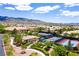 An aerial view of the community tennis courts and clubhouse, with a backdrop of scenic mountain views at 2467 Moonlight Valley Ave, Henderson, NV 89044