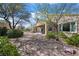 Relaxing backyard space featuring desert landscaping, shade trees, and a covered patio area perfect for entertaining at 2467 Moonlight Valley Ave, Henderson, NV 89044