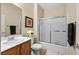 Bathroom vanity with wood drawers, a mirror, and a standing shower at 2467 Moonlight Valley Ave, Henderson, NV 89044