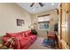 Cozy home office featuring a red couch, desk, and natural lighting at 2467 Moonlight Valley Ave, Henderson, NV 89044
