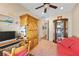 Cozy home office with built-in storage, desk, and comfortable red couch at 2467 Moonlight Valley Ave, Henderson, NV 89044