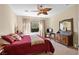 Comfortable bedroom featuring a ceiling fan, natural light, and a vanity at 2467 Moonlight Valley Ave, Henderson, NV 89044