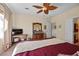 Bright bedroom featuring a ceiling fan, television, and decorative vanity at 2467 Moonlight Valley Ave, Henderson, NV 89044