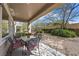 Covered patio featuring comfortable outdoor dining set with seating, offering a relaxing space for outdoor meals at 2467 Moonlight Valley Ave, Henderson, NV 89044