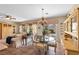 Dining space with backyard view, features an elegant light fixture, display cabinet, seamlessly connecting indoor and outdoor living at 2467 Moonlight Valley Ave, Henderson, NV 89044