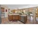 Open kitchen with wood cabinets, modern appliances, and a view of the backyard, blending indoor and outdoor spaces at 2467 Moonlight Valley Ave, Henderson, NV 89044