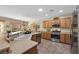 Bright kitchen with wood cabinets, stainless steel appliances, and a clear view to the dining area and backyard at 2467 Moonlight Valley Ave, Henderson, NV 89044