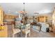 Combined living area with a kitchen, dining table, and living room, perfect for Gathering gatherings and entertaining guests at 2467 Moonlight Valley Ave, Henderson, NV 89044