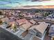 An aerial view of a residential neighborhood showcasing charming single-Gathering homes and neat landscaping at sunset at 2595 Amber Crest St, Las Vegas, NV 89142