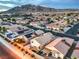 An aerial view of a residential area with neatly arranged houses, solar panels, and scenic mountain backdrop at 2595 Amber Crest St, Las Vegas, NV 89142