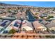 Overhead view of a suburban neighborhood with well-kept houses and green landscaping near a mountain range at 2595 Amber Crest St, Las Vegas, NV 89142