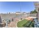 Backyard features a concrete perimeter, artificial turf, a block wall, and some plants at 2595 Amber Crest St, Las Vegas, NV 89142