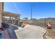 Backyard featuring an open patio, a BBQ grill, a block wall, and a desert landscape at 2595 Amber Crest St, Las Vegas, NV 89142